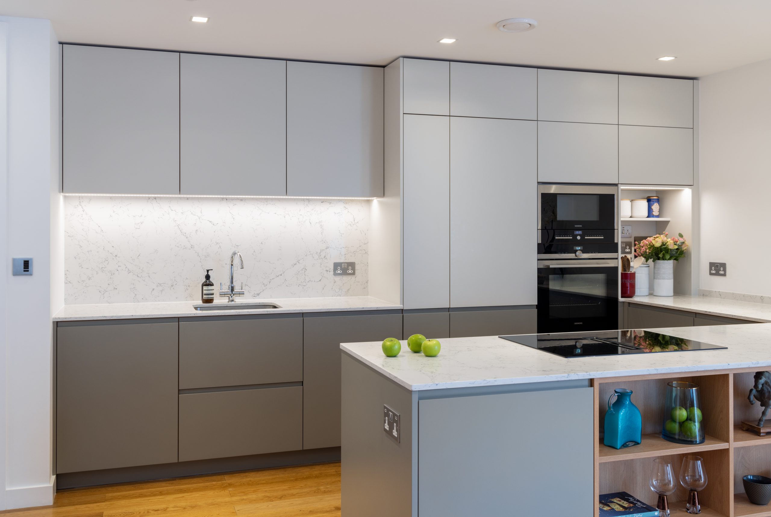 white marble splash back with grey kkitchen cupboards