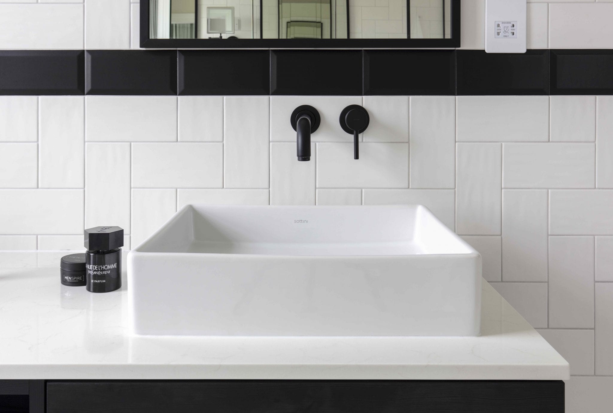 Black and white bathroom with modern taps