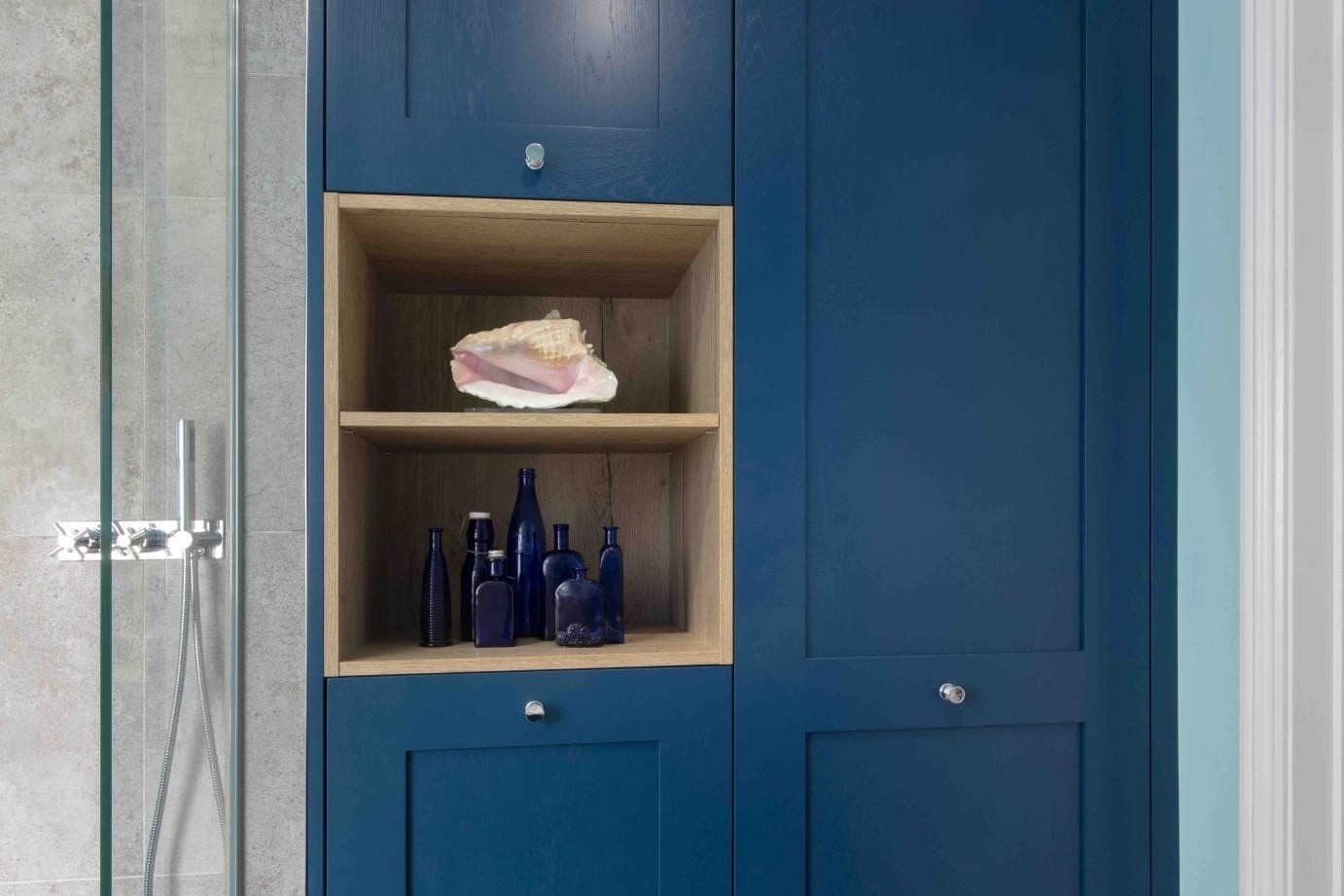 A bespoke cabinetry making the best use of space in the Southgate Road bathroom by Amberth