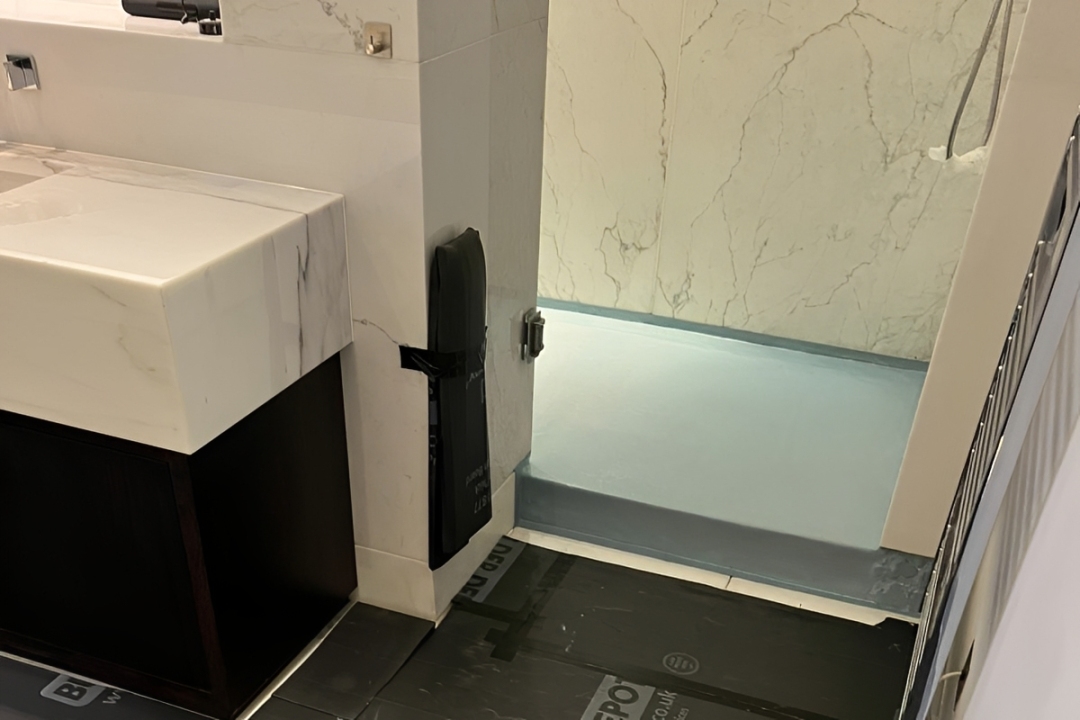 bathroom remedial work done by Amberth, showing repaired flooring after water damaging was fixed and sealed.