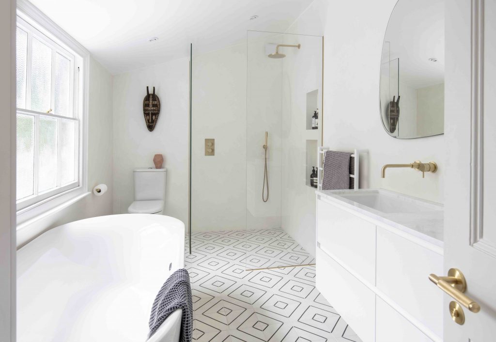 White modern bathroom with brass finishes