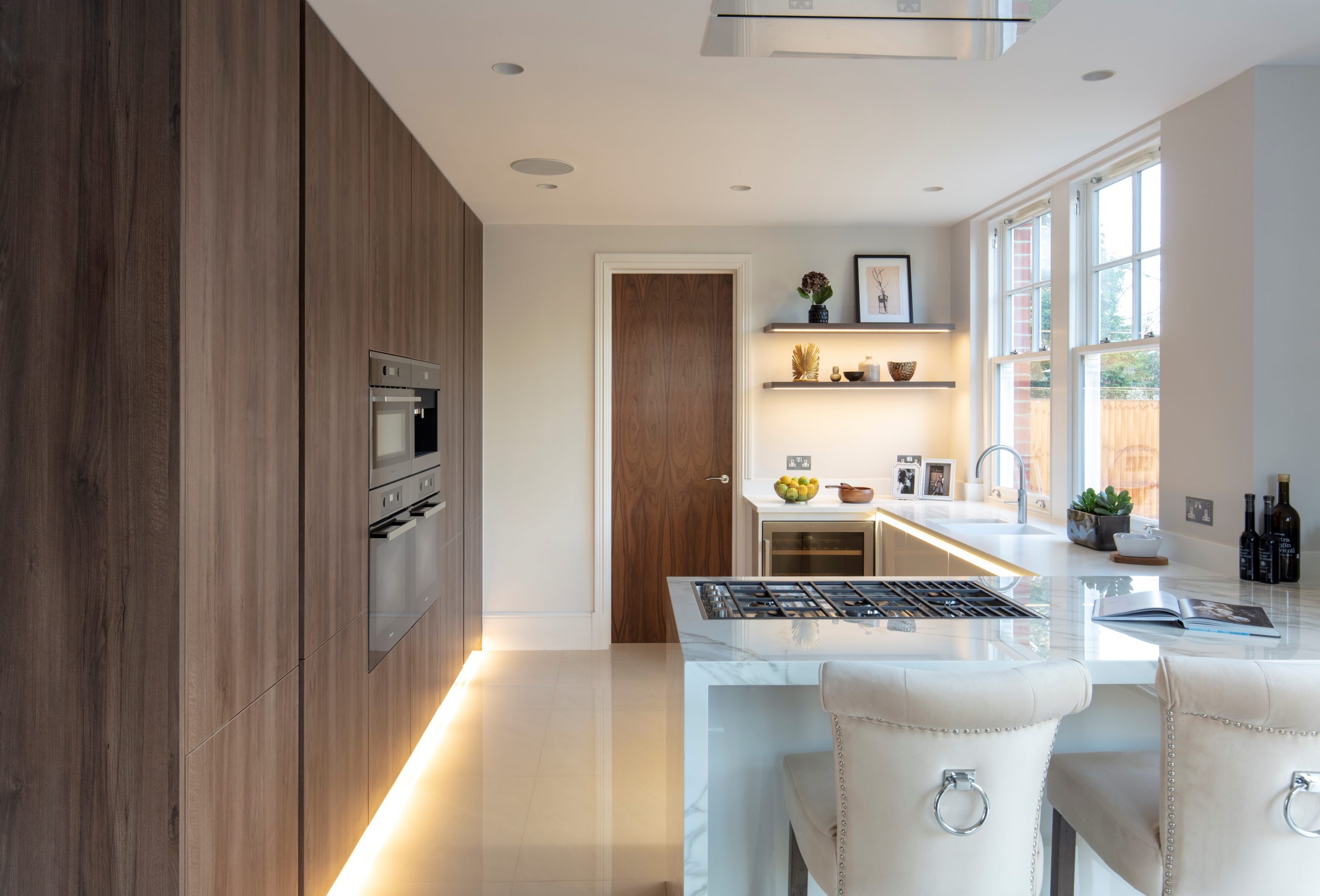 Open-plan kitchen and dining area with lowered ceiling detail and bespoke cabinetry